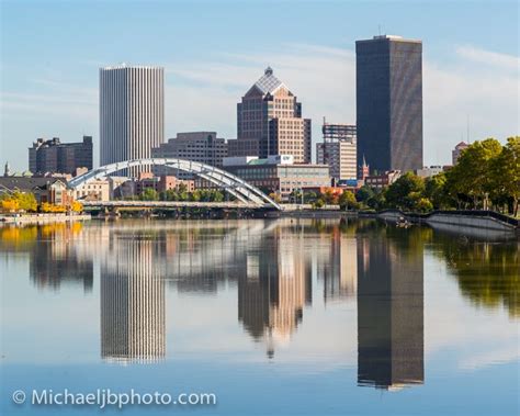 The Rochester Ny Skyline Reflecting On The Genesee River As Seen From