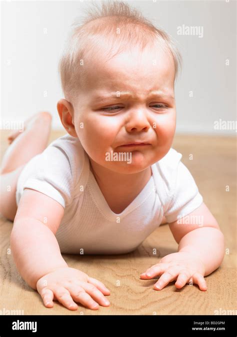 Baby Crying On The Floor Stock Photo Alamy