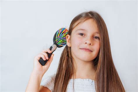 Cute Smiling Little Girl Combing Her Hair Comb Makes Hair Stock Photo