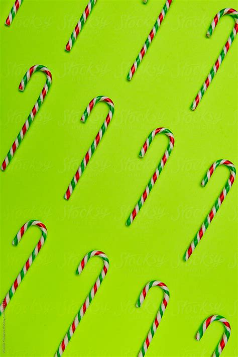 Candy Canes On Green Background By Stocksy Contributor Ronnie Comeau