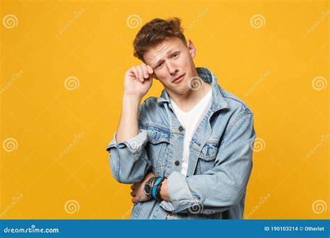 Portrait Of Crying Young Man In Denim Casual Clothes Looking Camera