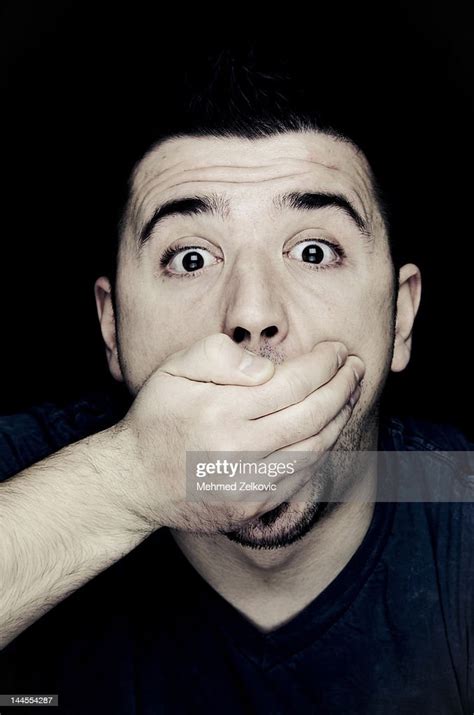Shocked Man With Hand Over Mouth High Res Stock Photo Getty Images