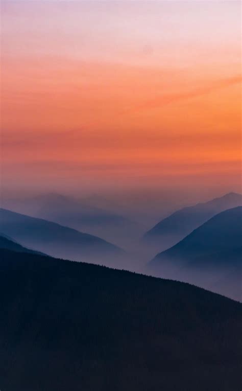 Download Wallpaper 950x1534 Hazy Sunset Mist Mountains Horizon