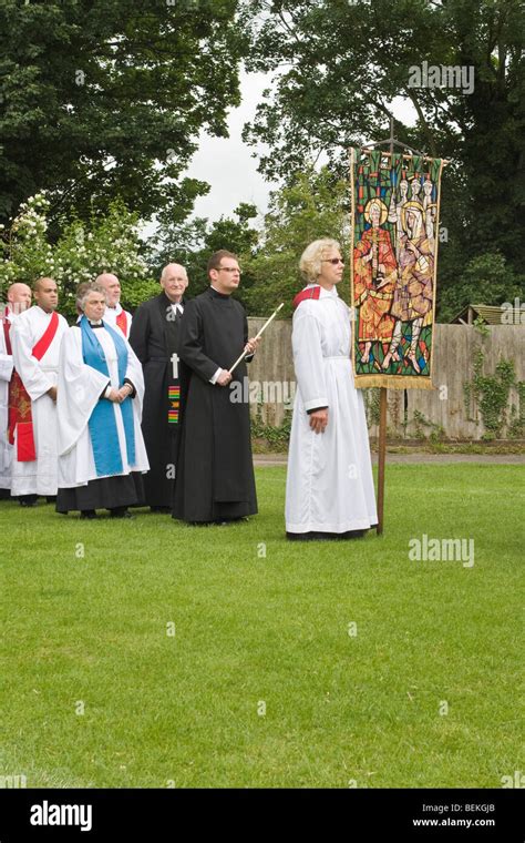 Woman Holding A Banner At Front Of Line Of Clergy During St Albans