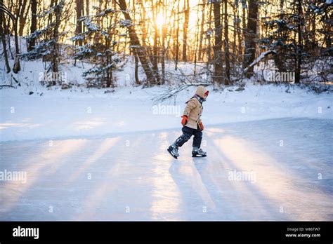 Boy Ice Skating On A Frozen Lake Stock Photo Alamy