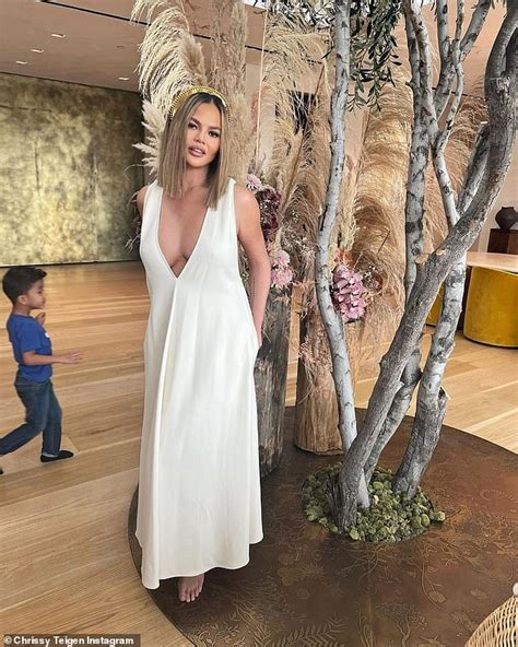Chrissy Teigen Puts On A Busty Display In A Plunging White Dress With A