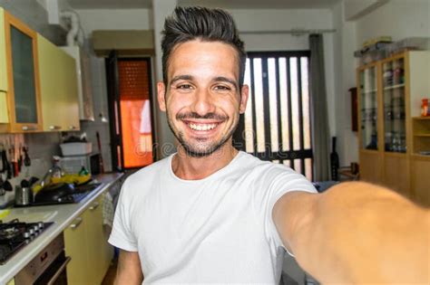 Handsome Caucasian Man Taking A Selfie Portrait Indoor At Home Happy