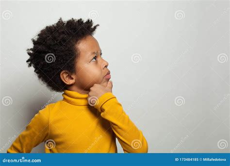 Small Black Kid Boy Thinking And Looking Up On White Background Royalty