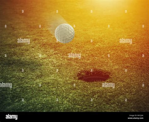 Golf Ball Near The Hole In A Grass Field Stock Photo Alamy