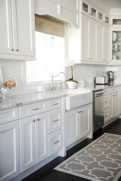 Handsome installer measuring white kitchen cabinet. 25+ Dreamy White Kitchens