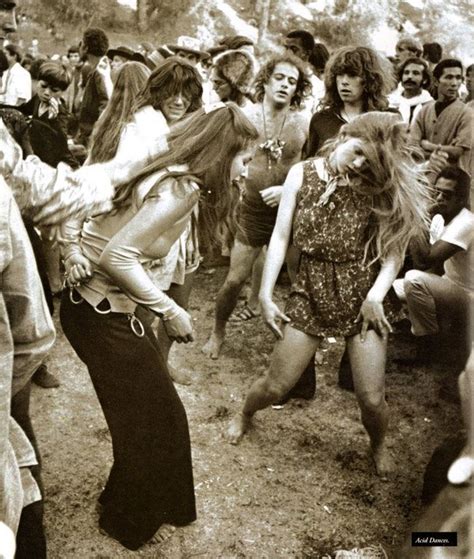 A Group Of People Are Dancing In The Dirt With One Woman Holding Her