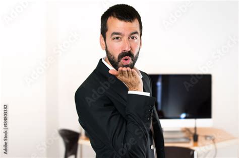Handsome Businessman Sending A Kiss In The Office Stock Photo And