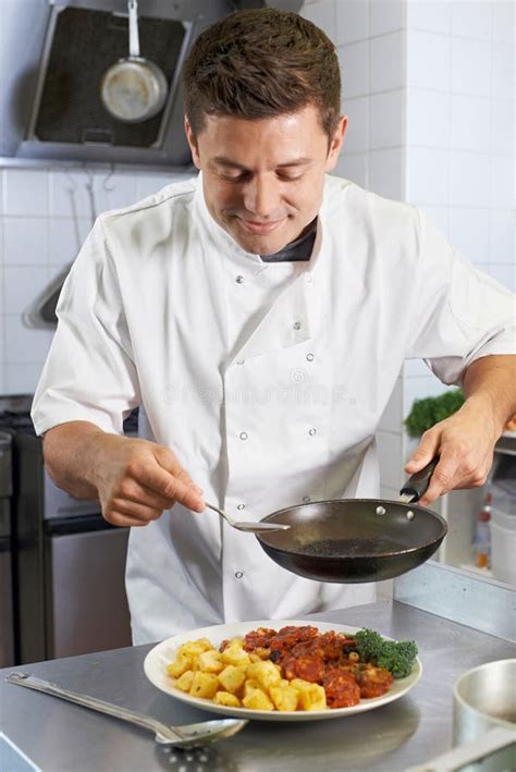 Chef Adding Sauce To Dish In Restaurant Kitchen Stock Image Image Of