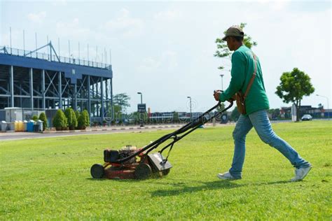 Man Cutting The Grass With Lawn Mower Editorial Stock Photo Image Of