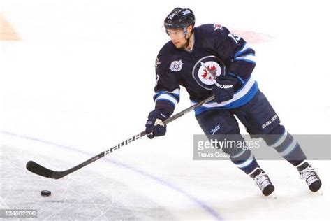 Kyle Wellwood Of The Winnipeg Jets Skates The Puck Through Centre Ice