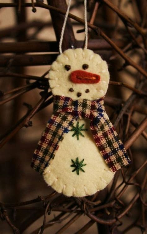 A Snowman Ornament Hanging From A Tree