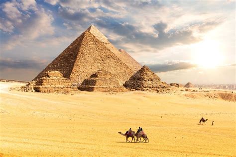 The Pyramids In The Desert Of Giza Egypt Sun And Clouds Scenery Stock