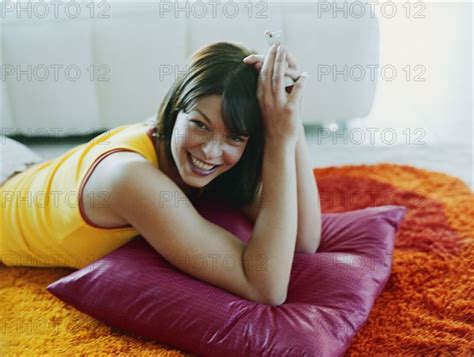 Woman Laying On Pillow On Floor Photo Tetra Images Deborah Jaffe