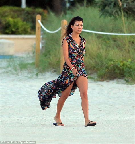 kourtney kardashian shows off her beach body as she frolics by the sea in a string bikini