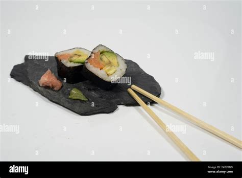 Two Pieces Of Sushi In A Blackboard Plate With Chopstick Ginger And