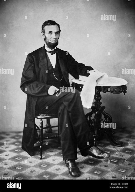 Us President Abraham Lincoln Portrait Seated Next To Table
