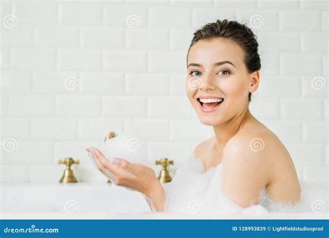 Beautiful Young Woman Sitting In Bathtub With Foam And Smiling Stock Image Image Of Young