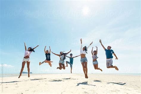 Group Of Happy People Jumping On A Tropical Beach By Stocksy