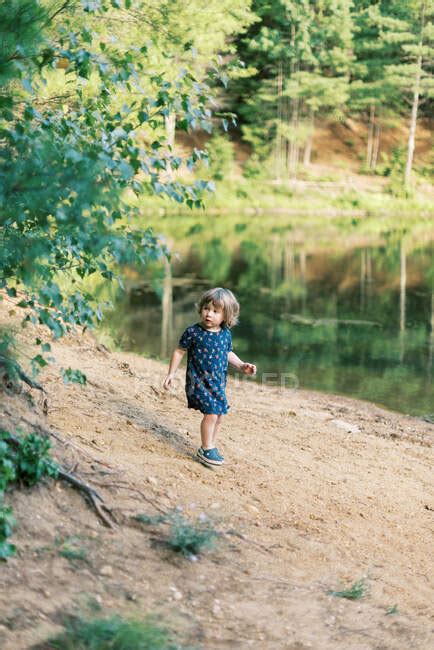 A Two Year Old Girl Exploring A Local Pond In The Woods — Sandals New