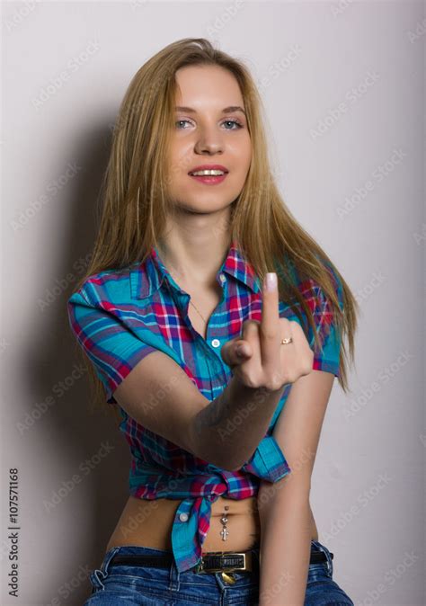 Close Up Portrait Of Sexy Young Girl In Jeans And A Plaid Shirt She Stretched Out Her Hand And