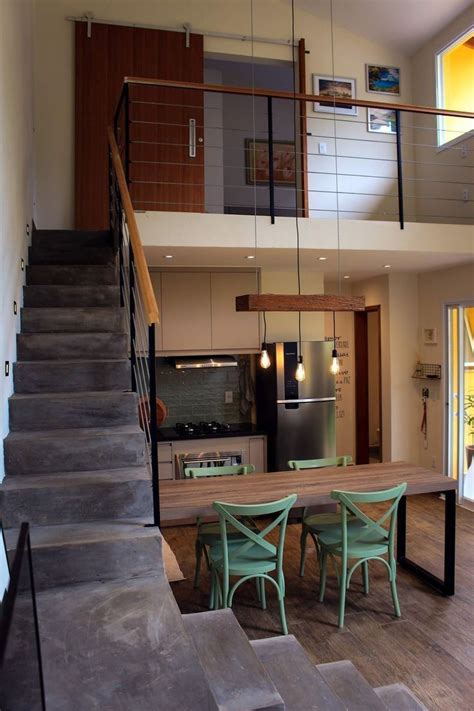 An Open Floor Plan With Stairs Leading Up To The Kitchen And Dining
