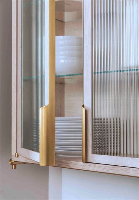 That's because glass never really upper kitchen cabinets with transparent glass doors let you put things on display while keeping everything safe inside, protected from dust and other things. Brass cupboard handles | Glass kitchen cabinets, Glass ...