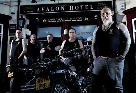 Portrait Of Group Of Bikers In Motorcycle Club Looking Tough Stock