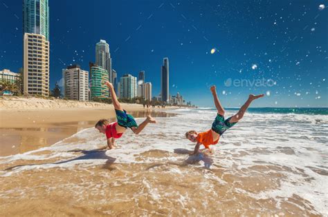 Two Happy Boys Doing Hand Stands On Gold Coast Beach Australia Stock