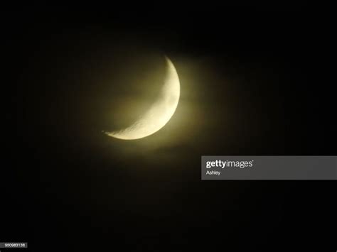 Close Up Detail Of A Crescent Moon Against A Black Sky High Res Stock