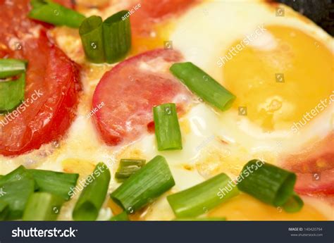 Fried Egg With Tomatoes And Onion On Pan Stock Photo 140420794