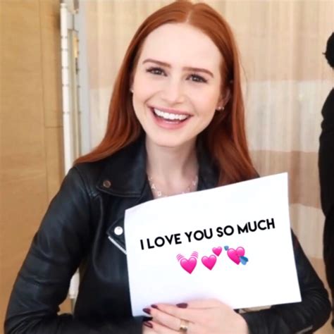 A Woman Holding Up A Sign With Hearts On It That Says I Love You So Much
