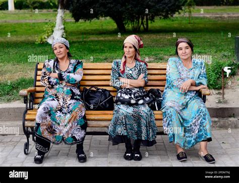 Uzbek Women Dressed In Uzbek Dresses Sitting On A Bench In A Park In Tashkent Uzbekistan Stock