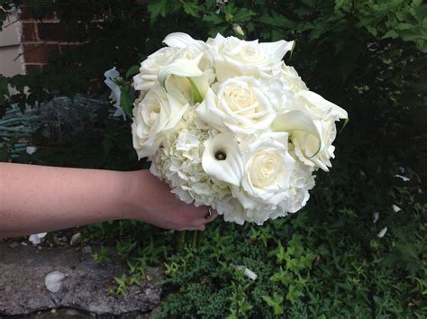 Classic white on white hand tied bridal bouquet. white hydrangea, white roses, and white mini 