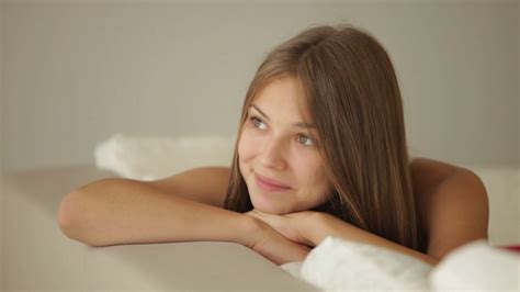 Charming Girl Relaxing On Sofa Looking At Stock Footage SBV