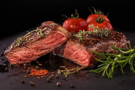 Sliced Grilled Beef Steak With Spices On Slate Slab Stock Photo Image