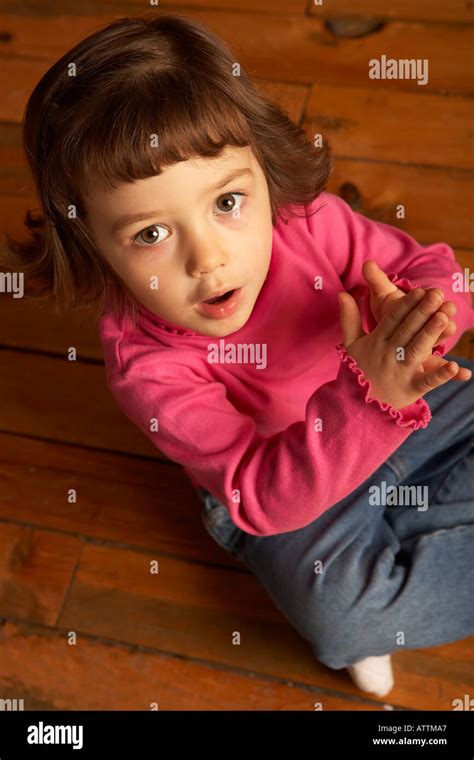 Girl Looking Up And Clapping Stock Photo Alamy