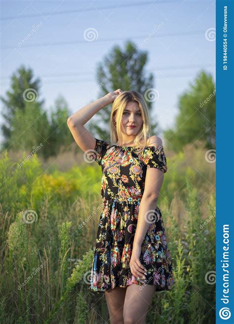 Overlight Bright Portrait Of A Charming Attractive Blonde In Flowery
