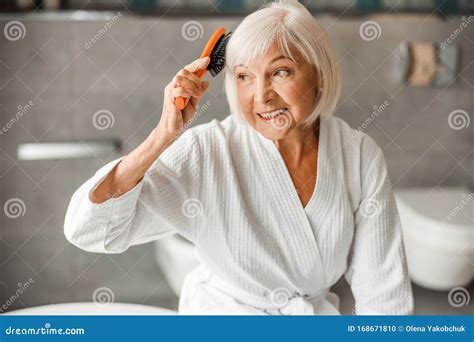 Lovely Old Woman Brushing Hair And Smiling Stock Photo Image Of