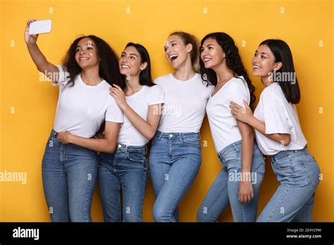 Happy Multiracial Ladies Making Selfie On Smartphone Over Yellow
