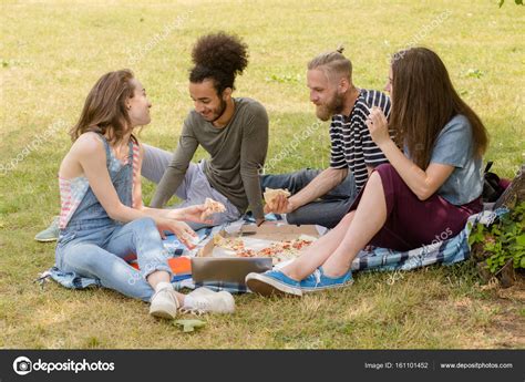 Young Multiethnic People Sitting On Plaid On Grass Eating — Stock
