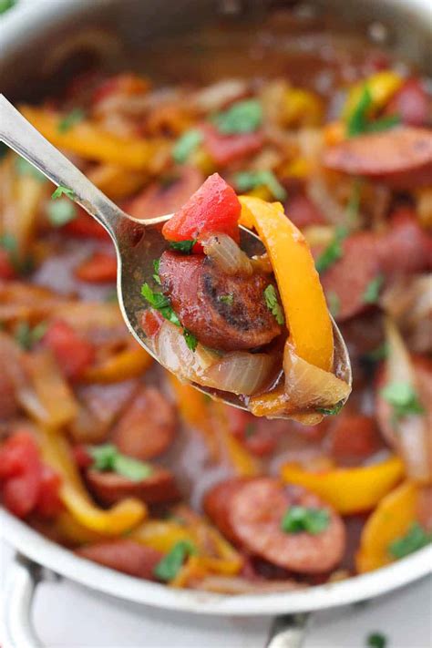 Remove sausages with slotted spoon from skillet letting fat drain; Sweet and Spicy Sausage with Peppers and Onions - Bowl of Delicious
