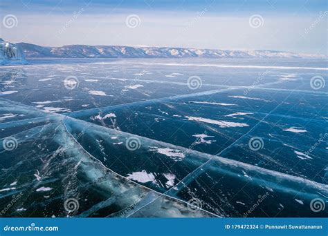 Baikal Frozen Lake In Winter Season With Cracks On Ice Floor Siberia
