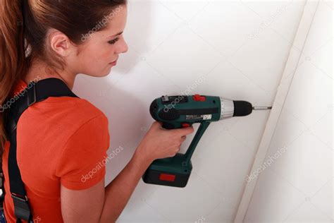 Woman Fixing Something On A Wall — Stock Photo © Photography33 8107046