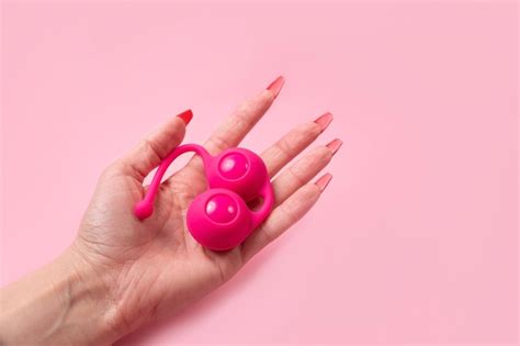 Premium Photo Toy For Adultsdildo In Hand On A Pink Wall