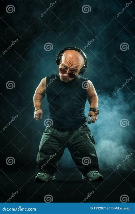 Portrait Of Stylish Midget Mc In With Headphones And Sunglasses Posing With Microphone Stock